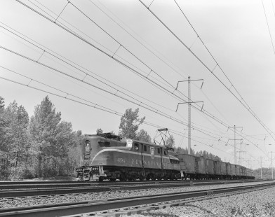 Pennsylvania Railroad GG1 eclectic locomotive no. 4894 leading  westbound passenger train no. 23 in Metuchen, New Jersey, on May 19, 1963. Photograph by Victor Hand. Hand-PRR-32-001