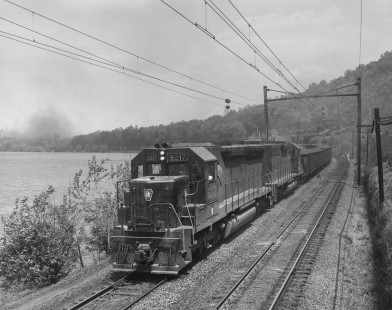 Penn Central SD45 diesel locomotive no. 6217, still wearing the paint of predecessor Pennsylvania Railroad, hauls a southbound coal train in Creswell, Pennsylvania, on May 18, 1969. Photograph by Victor Hand. Hand-NYC-PC-CR-31-0220