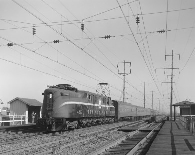 Penn Central GG1 electric locomotive no. 4877, still wearing the paint of predecessor Pennsylvania Railroad, hauling southbound passenger train no. 115 in Chester, Pennsylvania, on October 20, 1969. Photograph by Victor Hand. Hand-NYC-PC-CR-31-0276
