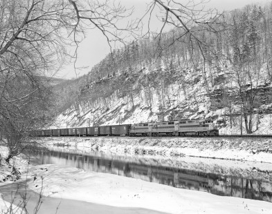 Erie Lackawanna Railroad locomotive no. 2251 hauls eastbound freight along the Canisteo River in West Cameron, New York, on March 24, 1965; Photograph by Victor Hand. Hand-EL-30-030.JPG