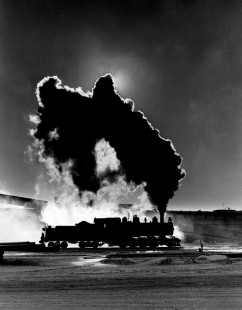 On a below-zero afternoon at Cloquet, Minnesota, steam from a Duluth & Northeastern locomotive covers the sun. The January 1962 photograph has been a symbol for the Center.