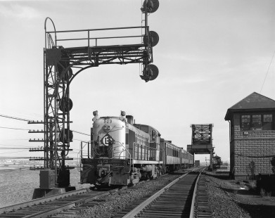 Erie Lackawanna Railroad locomotive no. 909 with passenger train enters Secaucus, New Jersey, via the HX Draw bridge, which connects Secaucus to East Rutherford, New Jersey, over the Hackensack River. HX tower is visible on right side of image. Hand shot this image on May 13, 1966. Photograph by Victor Hand. Hand-EL-30-095
