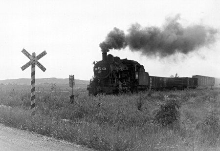 A steam-powered Milwaukee Road freight train passes through Prairie du Sac, Wisconsin, in the 1950s.