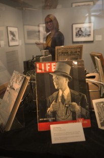 Hailey Paige, the Center's exhibitions and events coordinator, inspects the Beebe & Clegg exhibition in the California State Railroad Museum's Transcontinental Gallery. The exhibit includes a <i>Life</i> magazine cover featuring Lucius Beebe, on loan from John Gruber. Photograph for the Center for Railroad Photography & Art by Henry A. Koshollek