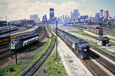 Burlington Northern unit (left) and Amtrak passenger train no. 40, the eastbound <i>Broadway</i>, operating on Penn Central leaving Chicago, Illinois, on July 15, 1972. Photograph by John F. Bjorklund, © 2016, Center for Railroad Photography and Art. Bjorklund-79-18-02