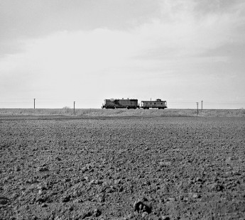 Northbound Missouri–Kansas–Texas Railroad local sprints across tilled fields near Taylor, Texas, with zero tonnage in March 1965. Photograph by J. Parker Lamb, © 2016, Center for Railroad Photography and Art. Lamb-02-040-08