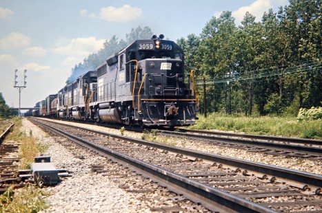 Eastbound Penn Central freight train on westbound main line with lead unit no. 3054 in Porter, Indiana, on July 3, 1971. Photograph by John F. Bjorklund, © 2016, Center for Railroad Photography and Art. Bjorklund-79-07-01
