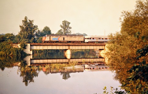 Westbound Amtrak passenger train no. 363, <i>St. Clair</i>, operating on Penn Central crossing the Huron River in Ann Arbor, Michigan, on August 26, 1973. Photograph by John F. Bjorklund, © 2016, Center for Railroad Photography and Art. Bjorklund-79-24-05