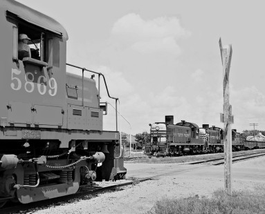 Southern Pacific Railroad local freight trains working between Austin and Burnet pass at Bertram, Texas, bringing together two generations of Alco road switchers in July 1976. Austin-bound train is at left. Photograph by J. Parker Lamb, © 2016, Center for Railroad Photography and Art. Lamb-02-050-05