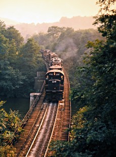 Southbound Conrail freight train crossing river in Yellow Creek, Ohio, on September 4, 1976. Photograph by John F. Bjorklund, © 2016, Center for Railroad Photography and Art. Bjorklund-80-12-04