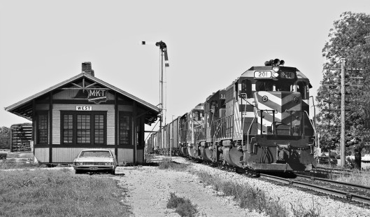 Southbound Missouri–Kansas–Texas Railroad manifest passes nicely decorated station at West, Texas, in July 1970. (See also Lamb-02-064-02) Photograph by J. Parker Lamb, © 2016, Center for Railroad Photography and Art. Lamb-02-044-08