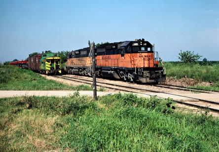 Westbound and eastbound Milwaukee Road freight trains meet in Seymour, Iowa, on July 11, 1981. Photograph by John F. Bjorklund, © 2016, Center for Railroad Photography and Art. Bjorklund-69-01-01