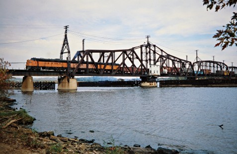 Westbound Milwaukee Road freight train crossing swing bridge over the Mississippi River in Sabula, Iowa, on October 21, 1978. Photograph by John F. Bjorklund, © 2016, Center for Railroad Photography and Art. Bjorklund-67-17-07