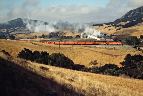 Southern Pacific Railroad passenger train, <i>Daylight</i>, led by steam locomotive no. 4449 and a diesel help at Stenner Creek in San Luis Obispo, California, on June 20, 1984. Photograph by John F. Bjorklund, © 2016, Center for Railroad Photography and Art. Bjorklund-86-16-01