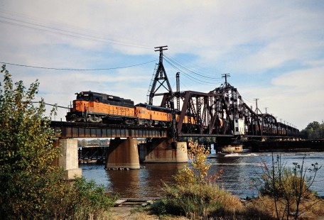 Westbound Milwaukee Road freight train crossing swing bridge over the Mississippi River in Sabula, Iowa, on October 21, 1978. Photograph by John F. Bjorklund, © 2016, Center for Railroad Photography and Art. Bjorklund-67-17-13
