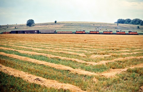 Eastbound Milwaukee Road freight train in Caledonia, Minnesota, on July 19, 1976. Photograph by John F. Bjorklund, © 2016, Center for Railroad Photography and Art. Bjorklund-65-07-06
