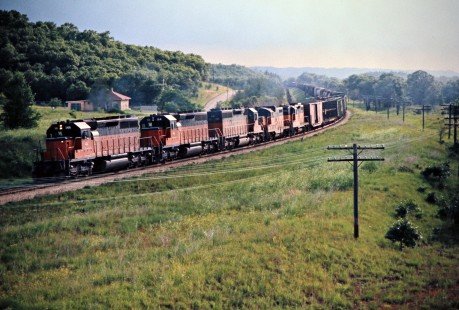 Eastbound Milwaukee Road freight train in Tunnel City, Wisconsin, on July 5, 1975. Photograph by John F. Bjorklund, © 2016, Center for Railroad Photography and Art. Bjorklund-64-26-10