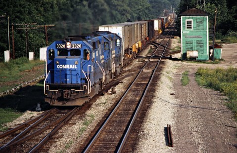 Westbound Conrail freight train passing Mohican Tower in Loudenville, Ohio, on June 21, 1980. Photograph by John F. Bjorklund, © 2016, Center for Railroad Photography and Art. Bjorklund-81-26-07