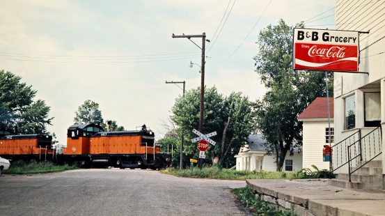 Eastbound Milwaukee Road freight train led by SW1 switchers at Prosper, Minnesota, on July 19, 1976. Photograph by John F. Bjorklund, © 2016, Center for Railroad Photography and Art. Bjorklund-64-29-05