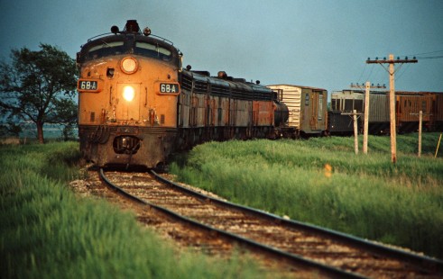 Westbound Milwaukee Road freight train in Postville, Iowa, on May 28, 1977. Photograph by John F. Bjorklund, © 2016, Center for Railroad Photography and Art. Bjorklund-65-16-02