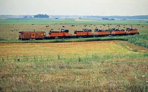 Westbound Milwaukee Road SW1 switchers and caboose at Caledonia, Minnesota, on July 20, 1976. Photograph by John F. Bjorklund, © 2016, Center for Railroad Photography and Art. Bjorklund-65-09-14