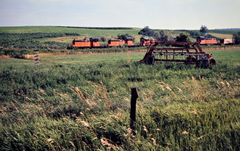 Eastbound Milwaukee Road freight train led by SW1 switchers in Mabel, Minnesota, on July 19, 1976. Photograph by John F. Bjorklund, © 2016, Center for Railroad Photography and Art. Bjorklund-64-29-01