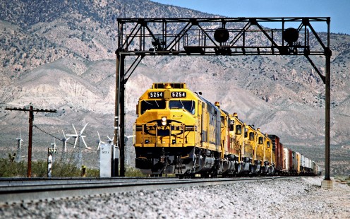 Eastbound Atchison, Topeka and Santa Fe freight train on Southern Pacific Railroad track in Mojave, California, on April 13, 1989. Photograph by John F. Bjorklund, © 2016, Center for Railroad Photography and Art. Bjorklund-87-19-07