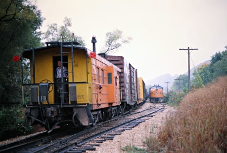 Northbound and southbound Milwaukee Road freight trains meet at Eckards, Iowa, on September 30, 1977. Photograph by John F. Bjorklund, © 2016, Center for Railroad Photography and Art. Bjorklund-65-22-17