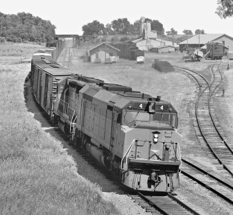 Westbound F45 leads Chicago, Milwaukee, St. Paul and Pacific Railroad freight train as it ducks under Chicago Great Western Railway line at Melbourne, Iowa, in June 1973. Photograph by J. Parker Lamb, © 2017, Center for Railroad Photography and Art. Lamb-02-107-09