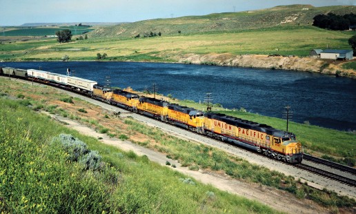 Westbound Union Pacific Railroad freight train along Snake River in Glenns Ferry, Idaho, on June 29, 1984. Photograph by John F. Bjorklund, © 2016, Center for Railroad Photography and Art. Bjorklund-90-12-18