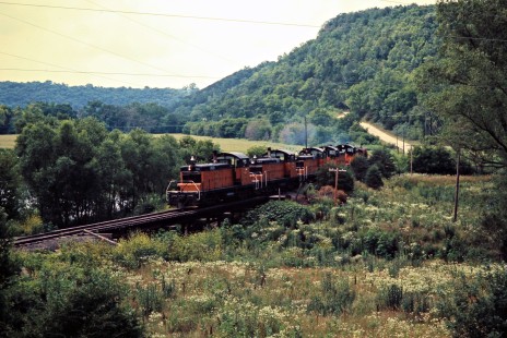 Eastbound Milwaukee Road SW1 switchers and caboose near Peterson, Minnesota, on July 20, 1976. Photograph by John F. Bjorklund, © 2016, Center for Railroad Photography and Art. Bjorklund-65-10-01
