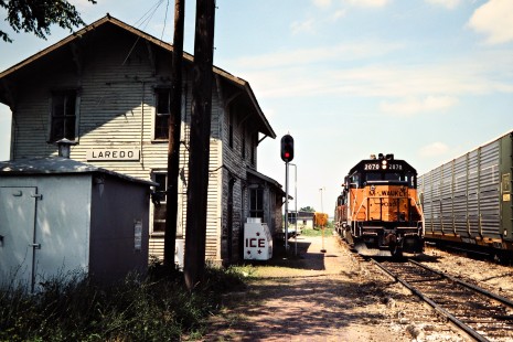 Westbound and eastbound Milwaukee Road freight trains meet at Laredo, Missouri, on July 9, 1981. Photograph by John F. Bjorklund, © 2016, Center for Railroad Photography and Art. Bjorklund-68-28-01