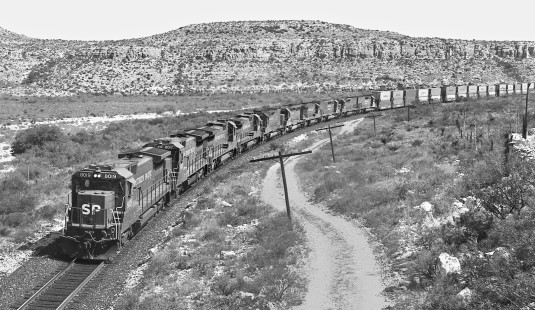Westbound Southern Pacific Railroad stack train, carrying extra units for power balance, approaches Sanderson, Texas, crew change in September 1987. Photograph by J. Parker Lamb, © 2017, Center for Railroad Photography and Art. Lamb-02-083-02