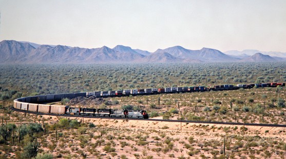 Southern Pacific Railroad freight train at Shawmut, Arizona, on April 2, 1988. Photograph by John F. Bjorklund, © 2016, Center for Railroad Photography and Art. Bjorklund-87-04-15.