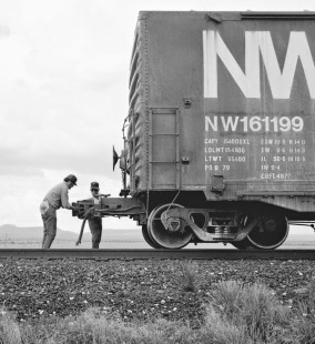 "My traveling companion and I had an unusual opportunity to assist the diligent crew members that operated the Southern Pacific Railroad trains we documented in July 1986. While pacing a westbound train west of Marfa, Texas, we observed a coupler knuckle break on one of the cars. Fortunately, we were able to ferry two crew members and their tools back to the car. Here we see the broken knuckle being replaced. By assisting the crew for about an hour, we saved them from having to walk back and forth from the head end (two or more miles). This would have shut down the main line." Photograph by J. Parker Lamb, © 2017, Center for Railroad Photography and Art. Lamb-02-087-12