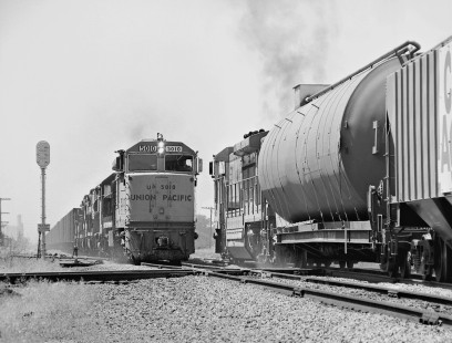 Westbound Union Pacific Railroad freight train passes a long coal train led by U50C locomotive no. 5010 at western edge of Fremont, Nebraska, in June 1973. Photograph by J. Parker Lamb, © 2017, Center for Railroad Photography and Art. Lamb-02-103-04