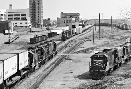Eastward view of Missouri Pacific Railroad's yard in Texarkana, Texas, shows a meet between trains and a waiting westbound in November 1980. In background, former passenger station sits astride Texas-Arkansas state line. Photograph by J. Parker Lamb, © 2016, Center for Railroad Photography and Art. Lamb-02-078-11