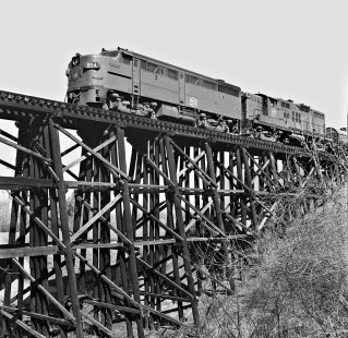 Northbound Missouri–Kansas–Texas Railroad local crosses trestle north of Smithville, Texas, in March 1965. Photograph by J. Parker Lamb, © 2016, Center for Railroad Photography and Art. Lamb-02-041-02