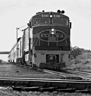Southbound Atchison, Topeka and Santa Fe Railway <i>Texas Chief</i> passenger train's fireman grabs orders at Milano, Texas, crossing of Missouri Pacific Railroad in May 1970. Photograph by J. Parker Lamb, © 2016, Center for Railroad Photography and Art. Lamb-02-067-02