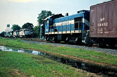 Northbound Kansas City Southern Railway coal train meets  Graysonia, Nashville & Ashdown freight train at Ashdown, Arkansas, on July 22, 1977. Photograph by John F. Bjorklund, © 2016, Center for Railroad Photography and Art. Bjorklund-61-21-10