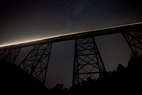 Southbound train streaking across the Copper Creek Viaduct near Clinchport, Virginia, on the clear night of August 7, 2010. The Milky Way can be seen behind the center of the bridge. See more of Bryan Pleasant's photography at <a href="http://www.bpleasantphotography.smugmug.com" rel="nofollow">www.bpleasantphotography.smugmug.com</a>.