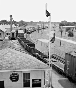 Southbound Missouri Pacific Railroad <i>Texas Eagle</i> passenger train passes freight at station in Round Rock, Texas, in June 1966. Photograph by J. Parker Lamb, © 2016, Center for Railroad Photography and Art. Lamb-02-059-09