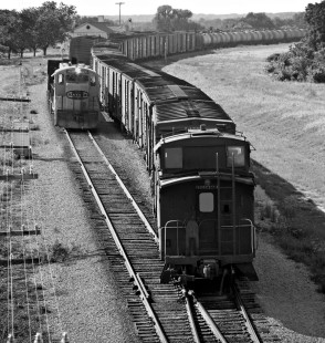 Final view of sequence of an Atchison, Topeka and Santa Fe Railway sulfur train passing a local freight train shows a cut of boxcars added to the regular consist of empty sulfur tanks in July 1977. Photograph by J. Parker Lamb, © 2016, Center for Railroad Photography and Art. Lamb-02-068-07