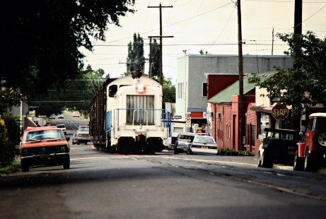 Paper mill switcher running down the street to interchange with the Southern Pacific Railroad in the town of Newburg, Oregon, on June 18, 1988. Photograph by John F. Bjorklund, © 2016, Center for Railroad Photography and Art. Bjorklund-87-05-18