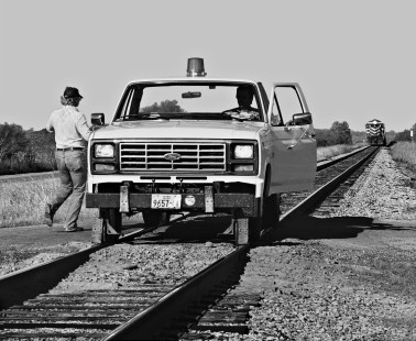 Missouri–Kansas–Texas Railroad track inspectors have finished lowering guide wheels for truck and are ready to leave yard in Smithville, Texas. Coal train in background is awaiting a crew change in August 1971. Photograph by J. Parker Lamb, © 2016, Center for Railroad Photography and Art. Lamb-02-044-11