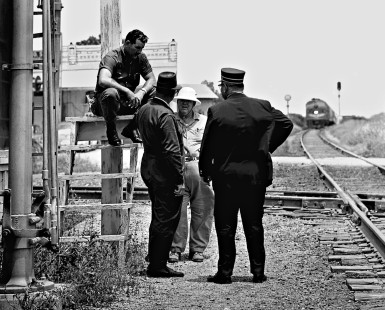 After a Southern Pacific local freight train stopped the Missouri Pacific's <i>Texas Eagle</i> passenger train at McNeil, Texas, an animated conversation ensued between the the crew members in August 1965. Photograph by J. Parker Lamb, © 2016, Center for Railroad Photography and Art. Lamb-02-049-12