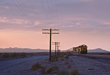 An eastbound Santa Fe Railway freight train at the Mojave Desert ghost town of Siberia, California, at sunset on March 27, 1990. Photograph by Fred M. Springer, © 2016, Center for Railroad Photography and Art. Springer-CO-CAL4-14-03