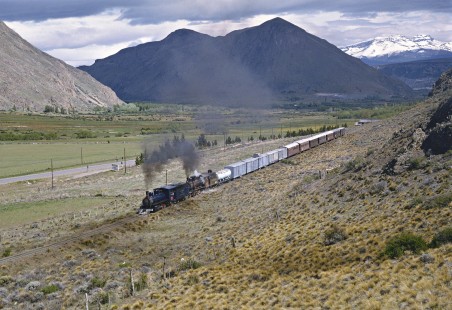 Two steam locomotives lead a train through the Andean foothills near Esquel, Argentina, on October 30, 1995. Photograph by Fred M. Springer, © 2016, Center for Railroad Photography and Art. Springer-CHI-ARG1-10-10