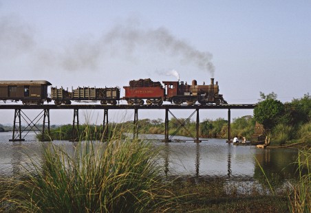 Wood-burning steam locomotive no. 59 crossing a low trestle as it departs Encarnación, Paraguay, on October 21, 1991. Photograph by Fred M. Springer, © 2016, Center for Railroad Photography and Art. Springer-ARG-PA-CHI-BO2-04-28