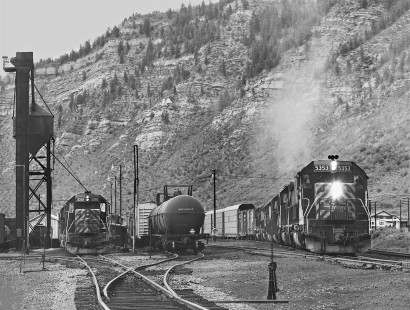 Eastbound Denver and Rio Grande Western Railroad freight train departs yard in Minturn, Colorado, behind six units for climb to Tennessee Pass in July 1980. Photograph by J. Parker Lamb, © 2017, Center for Railroad Photography and Art. Lamb-02-094-04
